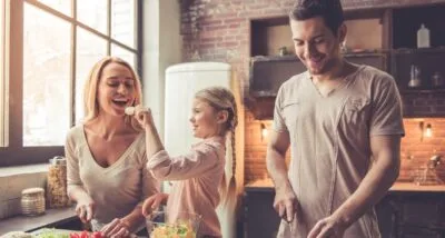 Happy Family in Kitchen covered by Cost Sharing Plans